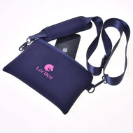 A navy blue neoprene Cross body bag by Hobby Horse LarDen features a zip closure, adjustable detachable strap, and a pink logo with horse graphic. A black smartphone peeks out from the unzipped pouch against a white background.