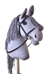 The Hobby Horse LarDen Black bridle with reins from strap is shown on a gray plush hobby horse with long yarn mane, mounted on a wooden stick and photographed against a white background.