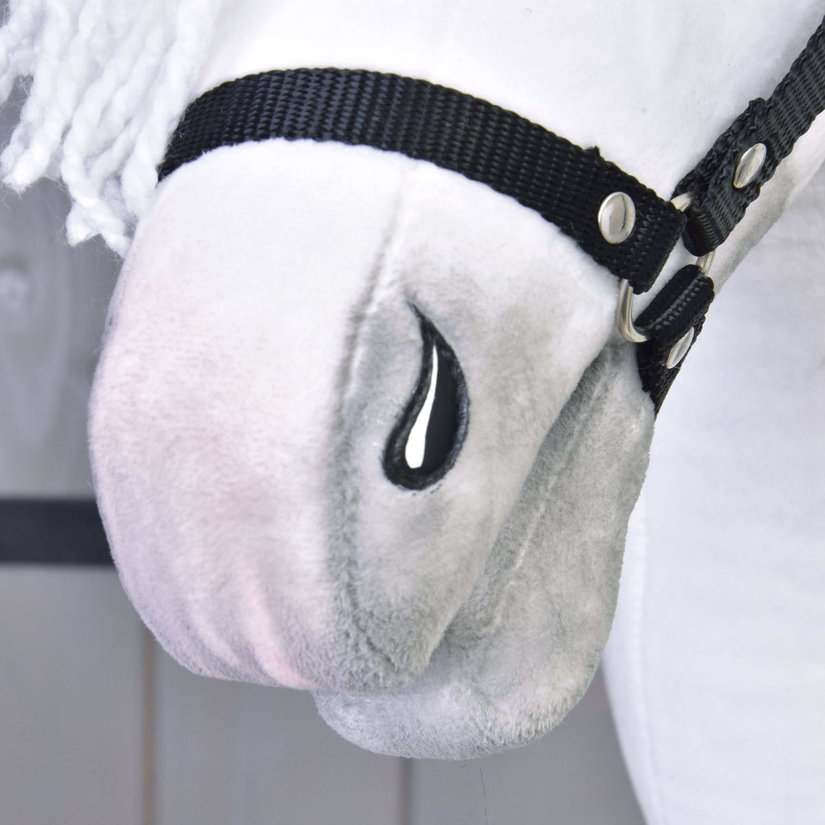 Close-up of the Hobby Horse LarDen’s Elektra with Black Halter, featuring a plush white face, black halter, embroidered black teardrop detail, soft texture, white yarn mane, and Lipizzaner Mare-inspired features.