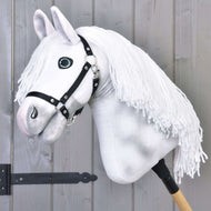 The Hobby Horse LarDen "Elektra" features a hand-painted white head with a black halter and long white yarn mane, mounted on a wooden stick and displayed in front of a light gray wooden wall.