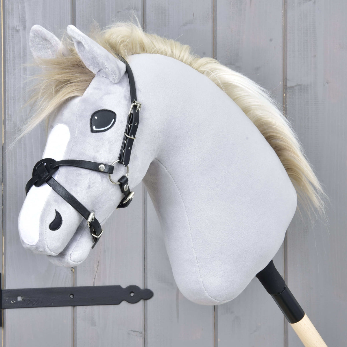 Hobby Horse Noseband Mexico Black by LarDen in black leatherette, crossed over the nose of a grey plush head