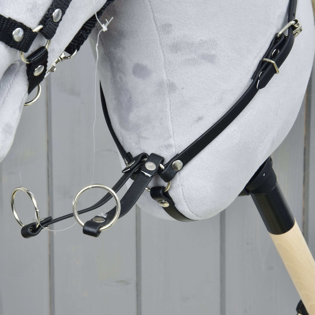 Close-up of the Martingale black where the neck strap meets the two fork straps with silver rings and rivets