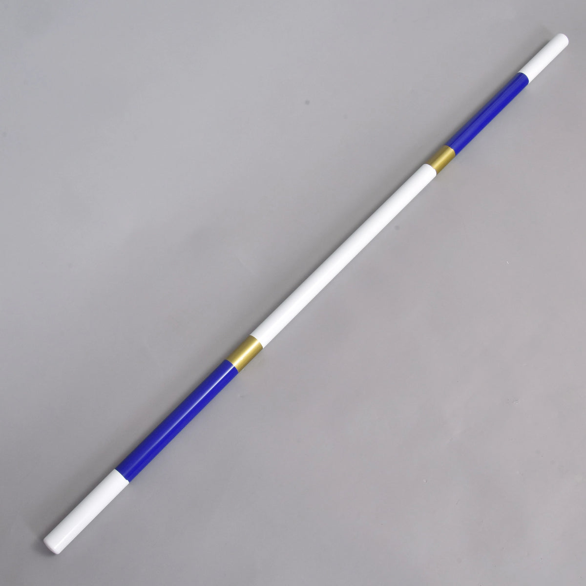 LarDen Hobby Horse Jump pole blue-gold with white ends, royal blue sections and gold bands, lying on a grey floor