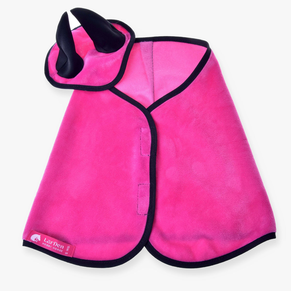 The Hobby Horse LarDen Set Hot Pink includes an ear bonnet–style cape with black trim and a matching headpiece featuring two black horns; the brand label is on the cape’s lower left side.
