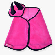 The Hobby Horse LarDen Set Hot Pink includes an ear bonnet–style cape with black trim and a matching headpiece featuring two black horns; the brand label is on the cape’s lower left side.