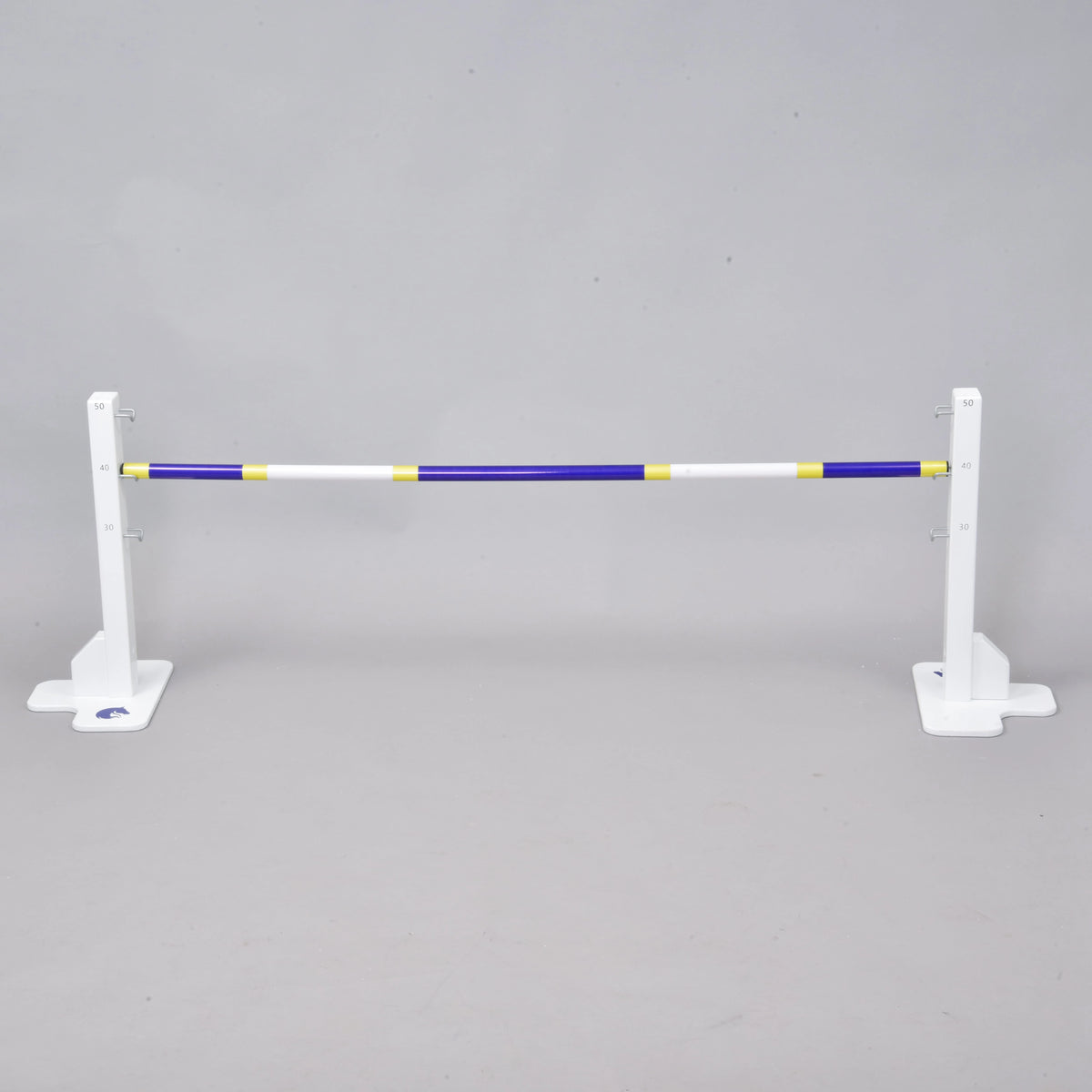 The Hobby Horse LarDen Jump 50 cm / 20 inch is a white adjustable jump stand with a blue, yellow, and white pole—ideal for indoor or outdoor hobby horsing—shown against a plain gray background.