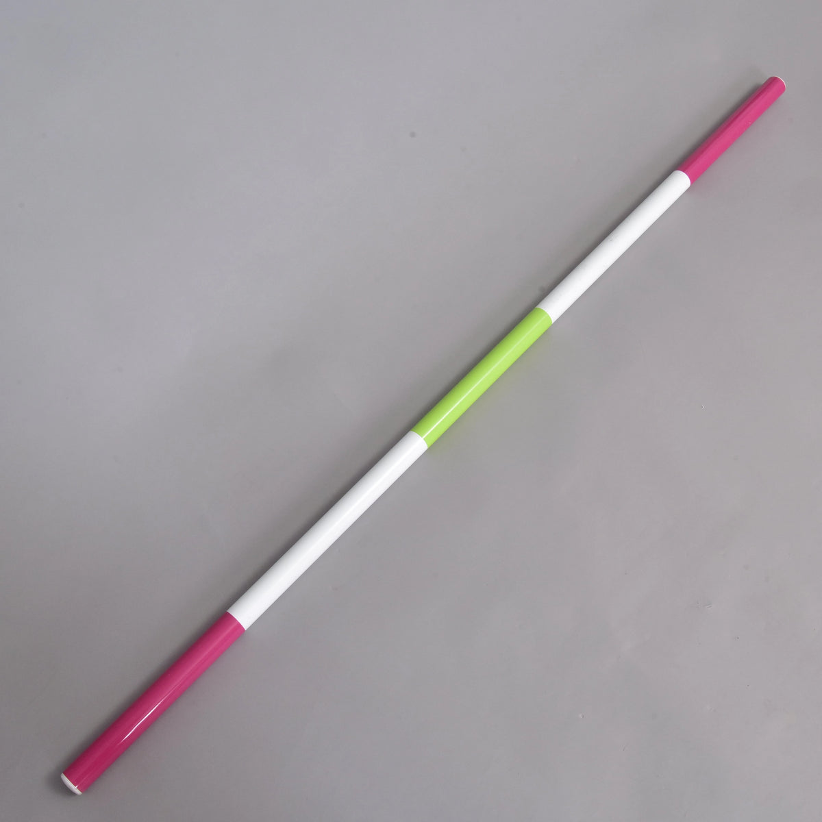 The Hobby Horse LarDen Jump pole pink-green, a lightweight 32 mm diameter pole with alternating pink, white, and a single green section, is shown diagonally on a plain gray background.