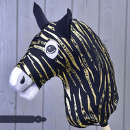 The Hobby Horse LarDen protective suit Zebra Gold (Lycra) features a black and gold zebra-striped head, black ears, white felt snout, and large cartoon eyes, shown in front of a light gray wooden wall.