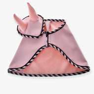 Set Abby by Hobby Horse LarDen is a light pink pet costume with black-and-white trim, styled like a cape with soft pink horns on the hood—a cute, ear bonnet-inspired look. Shown laid flat on a white background.