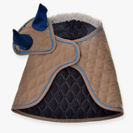 The Set Almond Star pet coat by Hobby Horse LarDen is quilted tan and navy with blue trim, features a hood shaped like an animal head with blue ears and horns, and is lined with soft white fleece for comfort.