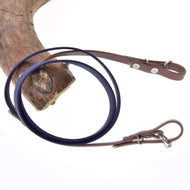 The Hobby Horse LarDen Reins rubberized brown purple are coiled on a tree branch against a white background, showcasing their unique blend of brown and purple tones.