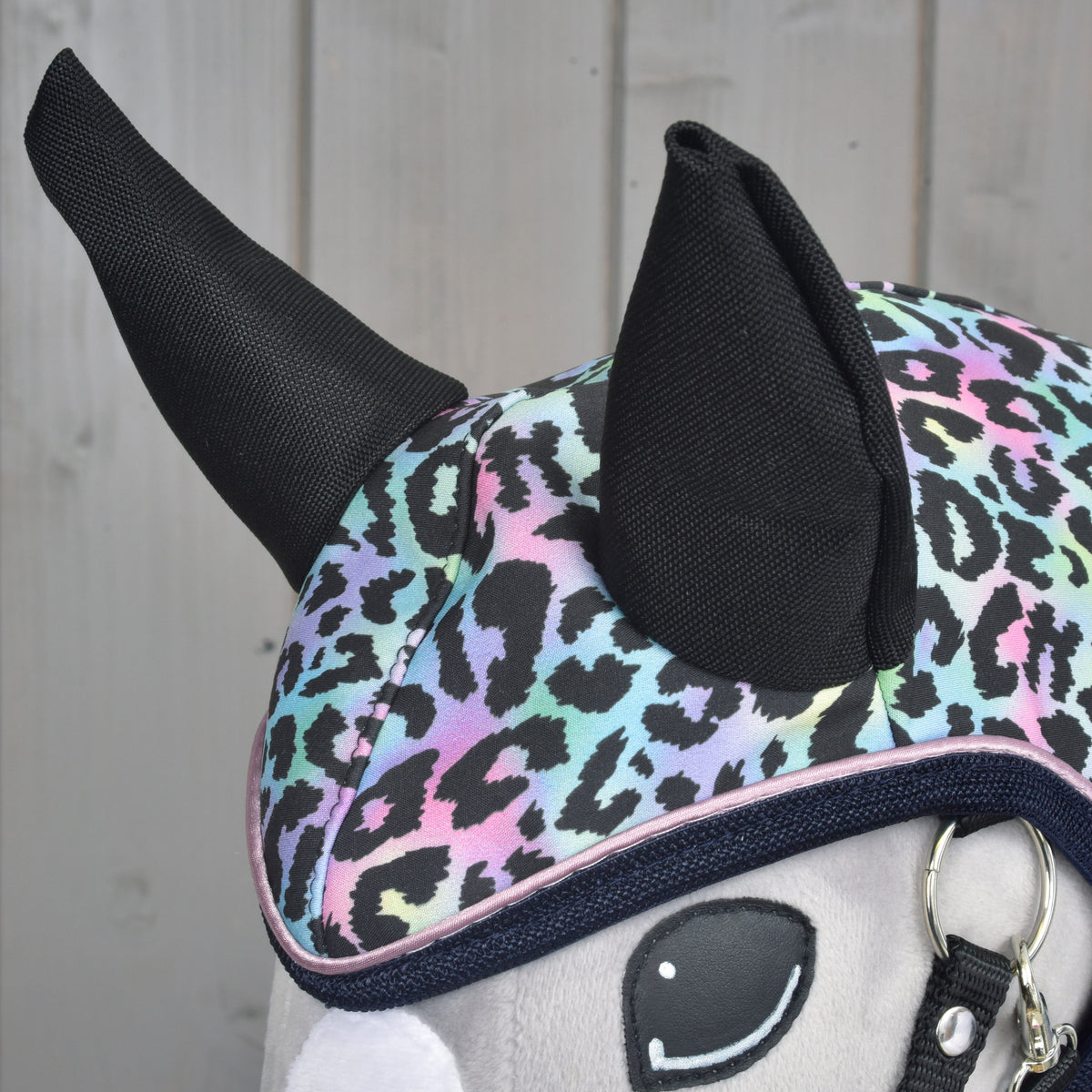Close-up of Hobby Horse Raincoat Confetti (softshell) with black ears and pink piping
