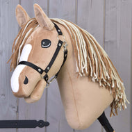 The Hobby Horse LarDen's "Hobby Horse Bren with Black Halter" features a light brown body, white facial markings, long yarn mane, and is pictured against a wooden background.