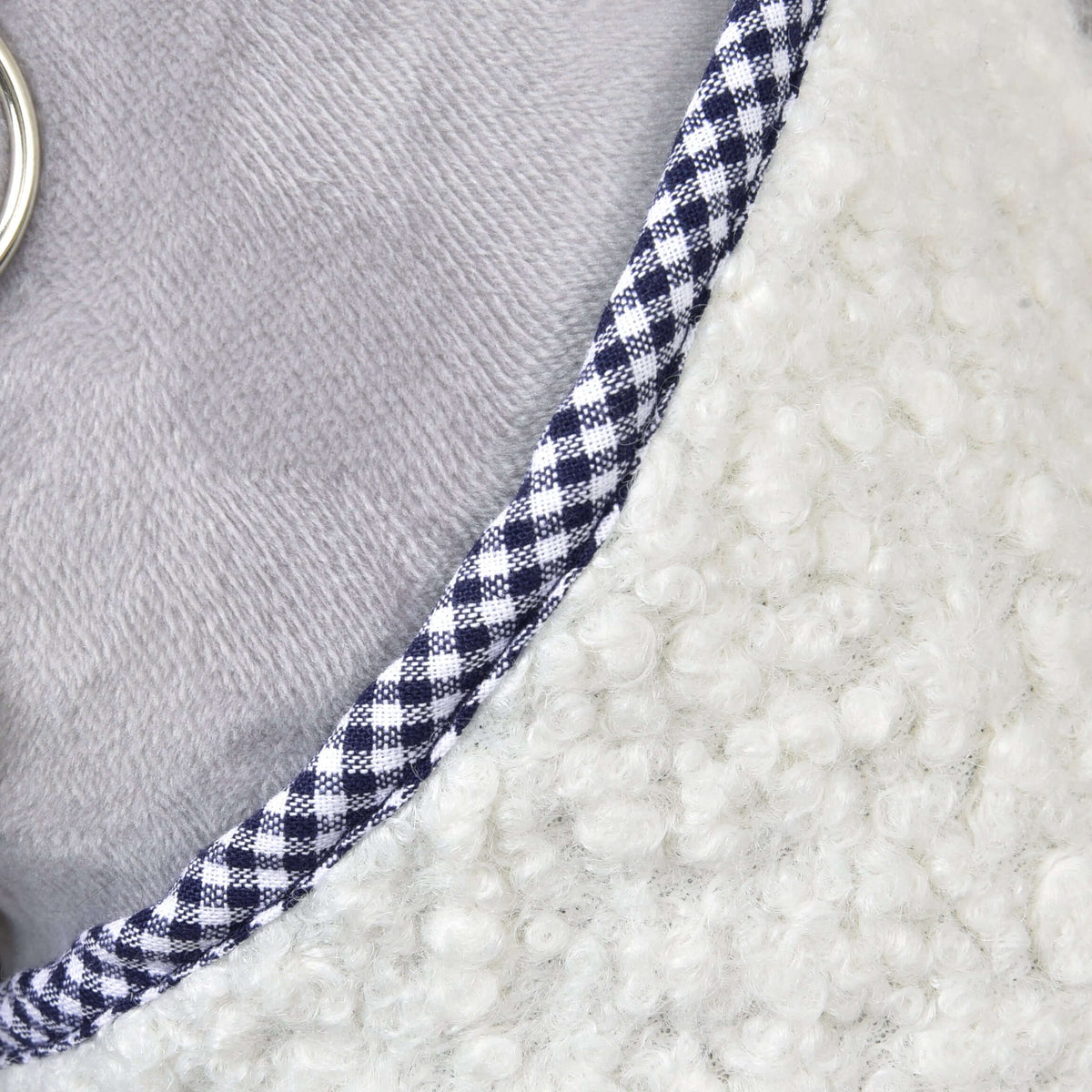 Close-up of the Blanket cube blue by Hobby Horse LarDen, highlighting its textured white fleece, blue-and-white checkered trim, smooth light gray fabric, and a small silver ring on the left edge.