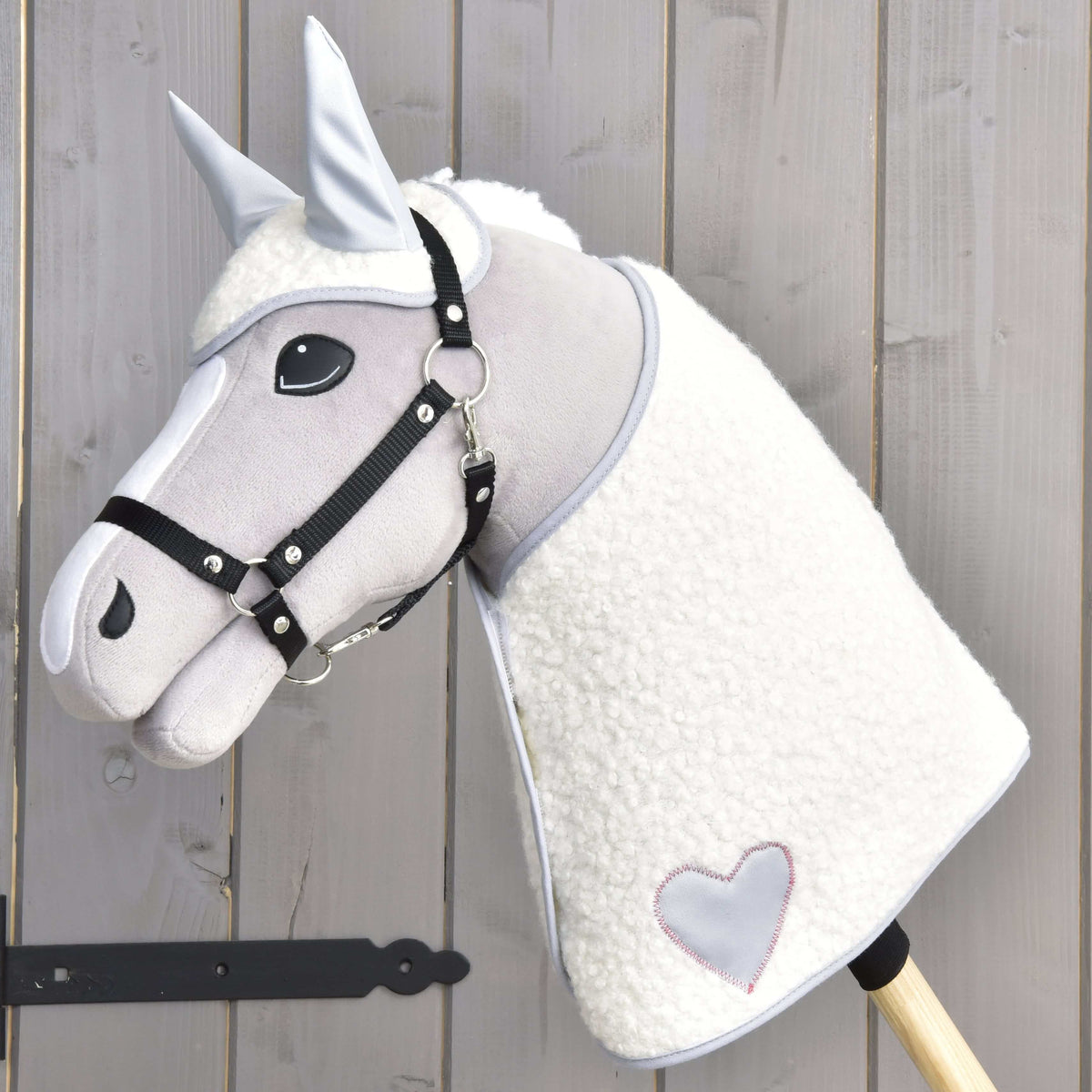 The Hobby Horse LarDen Set Snowflake features a gray and white plush hobby horse with a bridle, faux fur mane, and stitched heart on its neck—perfect for imaginative play or pairing with your favorite blanket set.