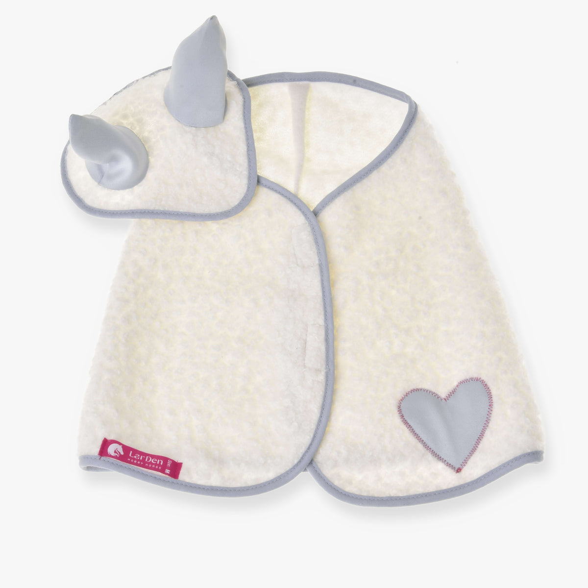 The Set Snowflake by Hobby Horse LarDen features a soft, white baby cape with a heart patch, blue trim, and a matching hood with blue horns—resembling a playful ear bonnet. The cape is laid flat with a pink label at the bottom left.