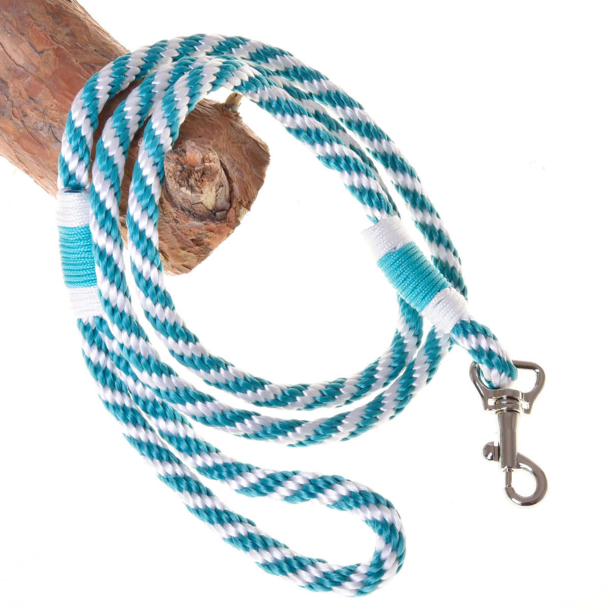 The Hobby Horse LarDen Set Start Turquoise (halter, cordeo, lead rope, reins) features a turquoise and white striped design with metal clasp, looped around wood on a white background—ideal stylish accessories for your hobby horse.