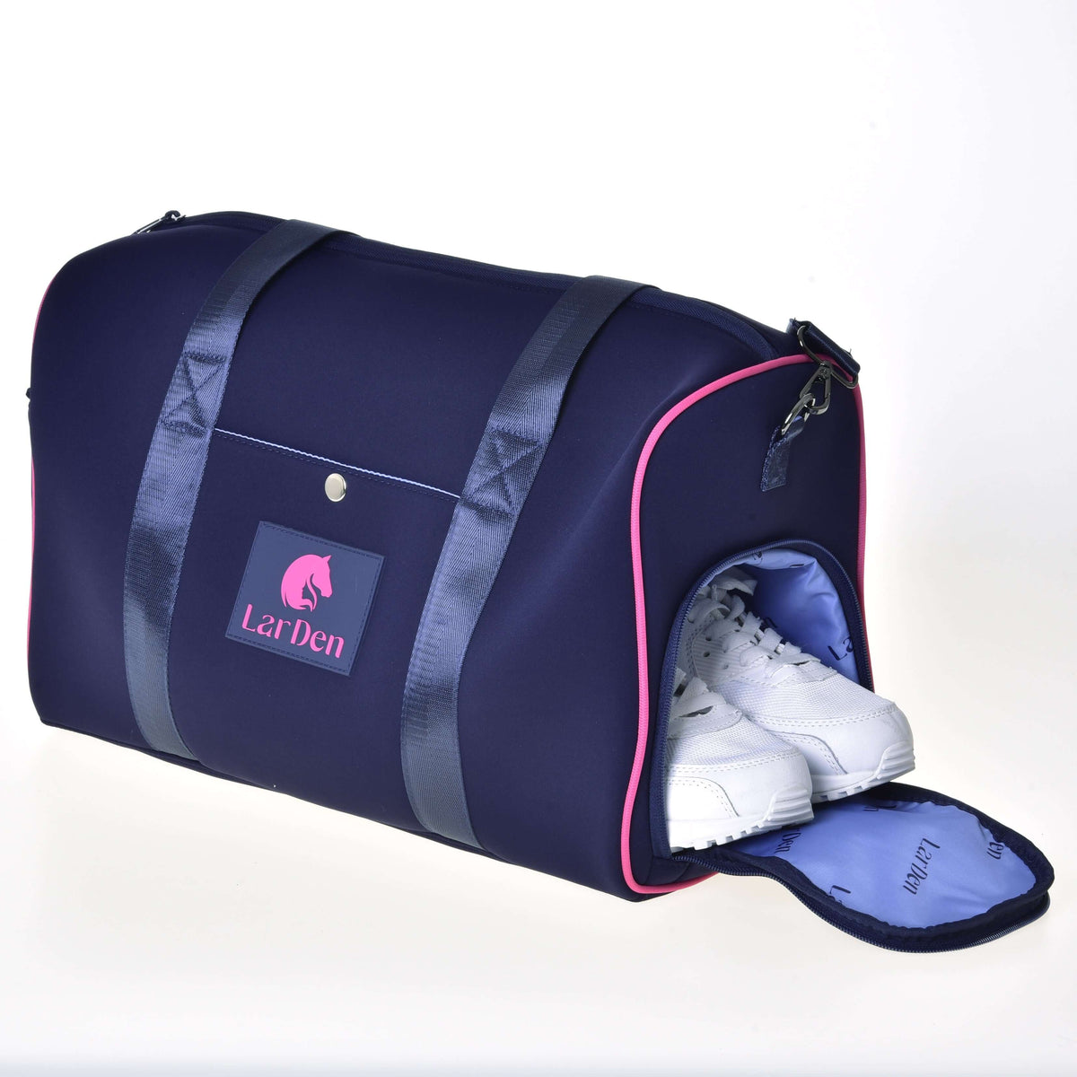 White trainers in the separate shoe compartment at the end of the navy Hobby Horse Sports bag with pink piping