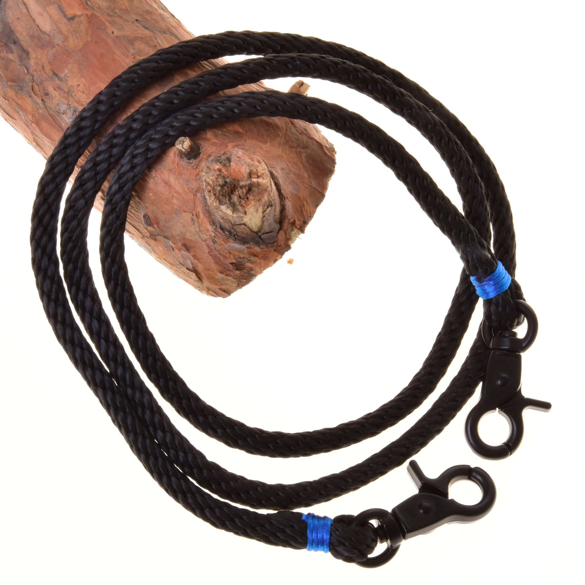 Hobby Horse Reins Azure by LarDen, black braided rope reins with bright blue wraps and black snap hooks over a branch