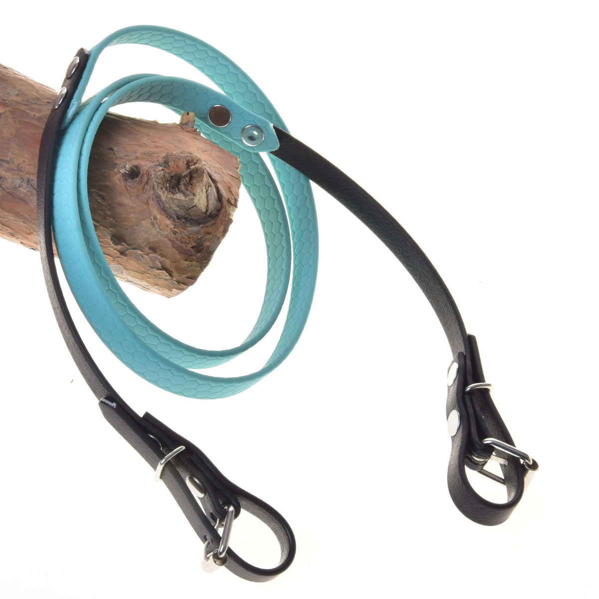 The Hobby Horse LarDen Reins rubberized turquoise, featuring a textured turquoise handle and black accents, are looped over wood and displayed on a white background, resembling stylish reins.