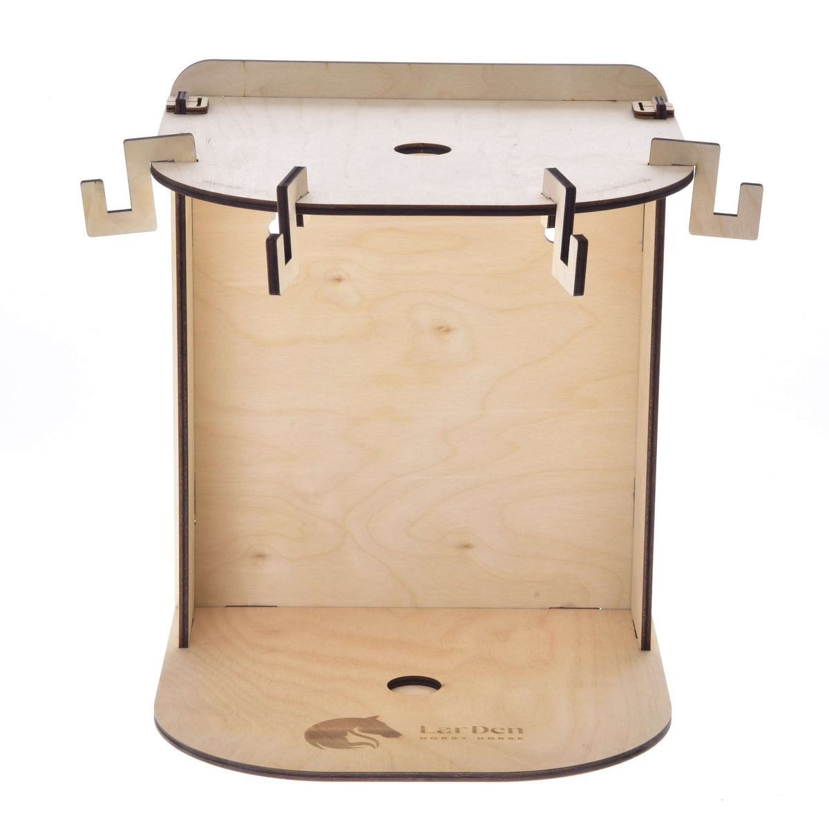 The Small Hobby Horse Stable by Hobby Horse LarDen is a wooden, flat-pack stand with interlocking tabs, cutouts, and a laser-etched LarDen logo—ideal for displaying your favorite plywood hobby horse.