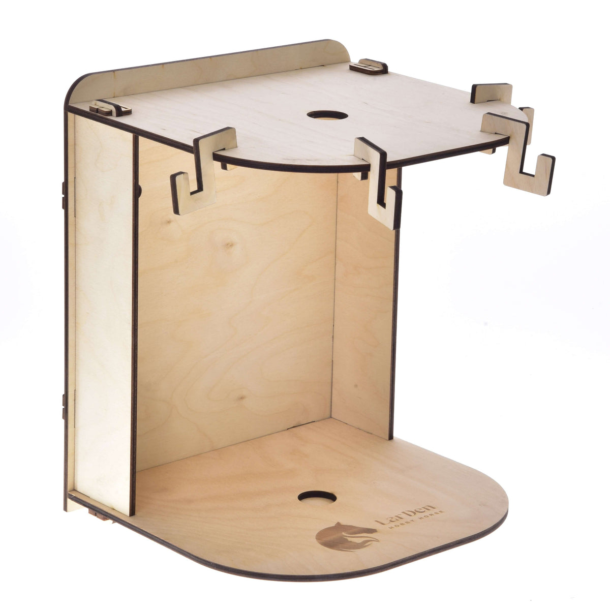 The Hobby Horse LarDen Small Hobby Horse Stable is a wooden, laser-cut stand with a curved shelf, multiple hooks, and circular cutouts. It features the brand logo on the base and upper shelf, ideal for assembling or displaying hobby horses.