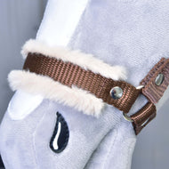 Close-up of Hobby Horse LarDen's "Halter brown with fur," a light gray plush hobby horse accessory with a brown halter, white faux fur trim, metal studs, and a stitched black teardrop-shaped detail.