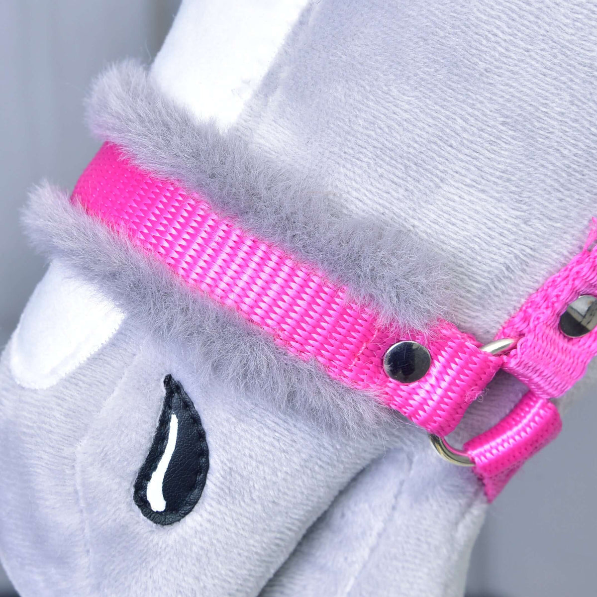 Close-up of a gray plush toy wearing the "Halter pink with fur" by Hobby Horse LarDen, featuring bright pink color, metal hardware, and soft fluffy gray trim.