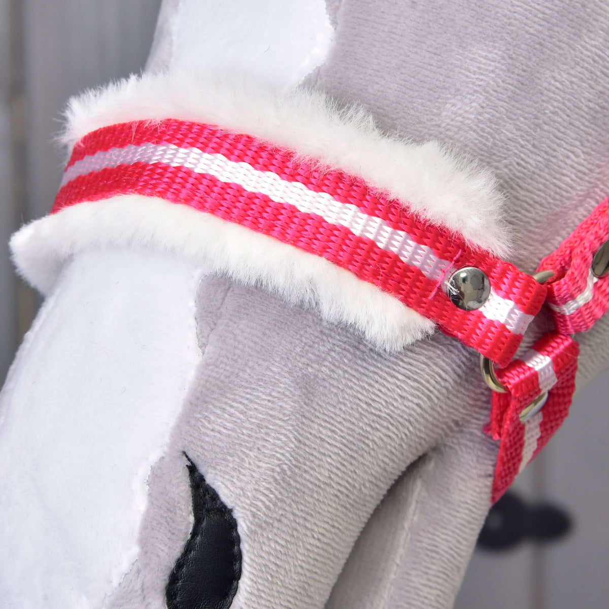 Close-up of the Hobby Horse LarDen "Halter red stripe with fur," showcasing its soft gray and white plush, white faux fur padding, and red and white striped strap with a metal rivet.
