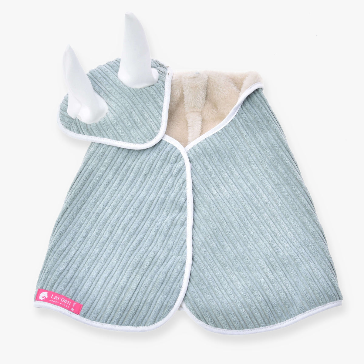 The Set Manchester Little Green by Hobby Horse LarDen is a ribbed, light blue pet cape with white trim and soft white horns on the hood, lined with beige fleece and finished with a pink Lil Pets tag—perfect for pairing with any blanket set or bonnet.
