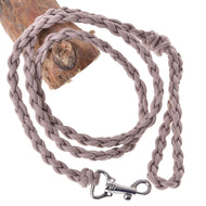 The Hobby Horse LarDen Knitted Lead Rope Almond, hand-knitted in beige and braided, features a sturdy metal clasp and is coiled on wood against a white background.
