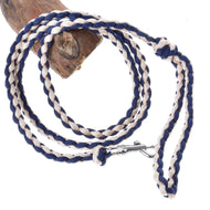 The Hobby Horse LarDen Knitted Lead Rope Cremo-Blue features a coiled, hand-knitted navy blue and beige rope with a silver metal clasp, shown looped around wood on a white background.