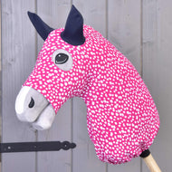 The Hobby Horse LarDen "Hobby Horse Protective suit Minie (Lycra)" is a pink hobby horse with white spots, grey snout, black ears, wooden stick handle, and features a washable Lycra cover for easy cleaning.