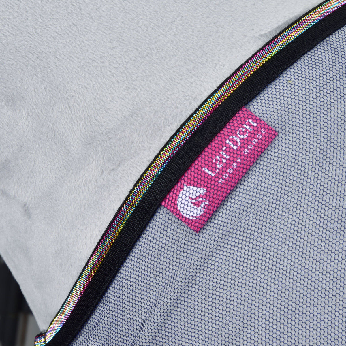 Close-up of mesh fabric with a pink Set Fly Combo tag featuring a cat face icon by Hobby Horse LarDen, bordered with multicolored trim—a stylish accessory for your hobby horse—shown on a light gray background.