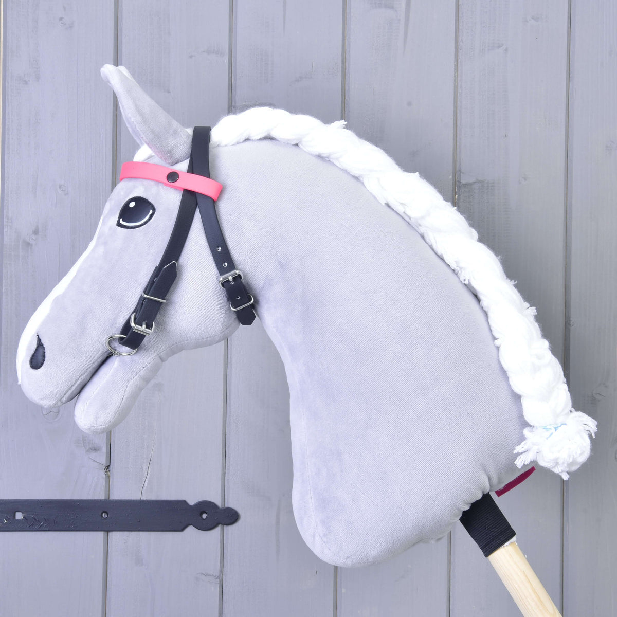 LarDen Bridle with 2 Headbands Pink on a grey plush Hobby Horse, black straps with a plain pink browband