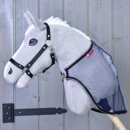A plush gray Hobby Horse LarDen with a black bridle and the Fly sheet LarDen attached, shown against a light gray wooden door with a black hinge.