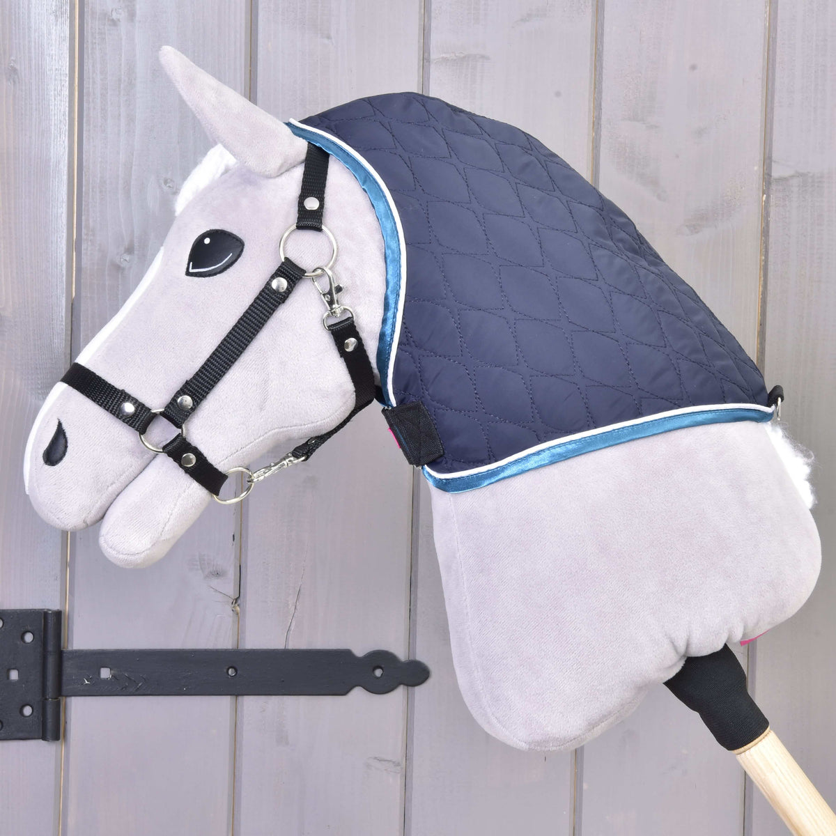 Grey Hobby Horse wearing only the navy quilted neck cover over the top of its neck, edged in blue and white