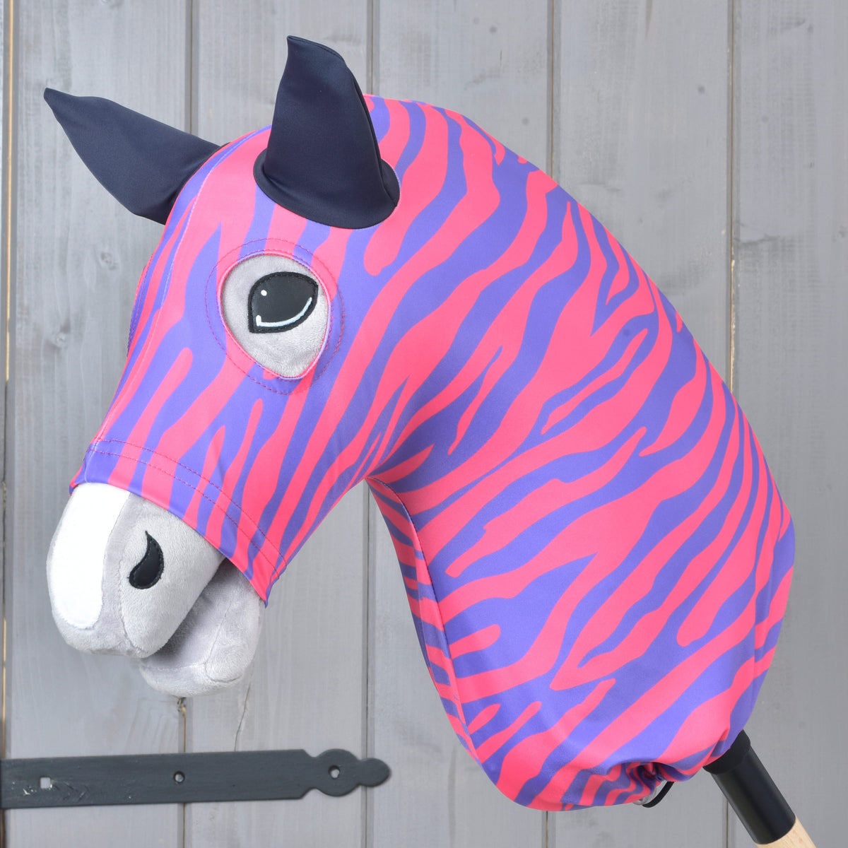 Hobby Horse protective suit Fancy by LarDen in pink and purple lycra worn on a grey Hobby Horse