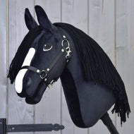 The Hobby Horse LarDen "Hobby Horse Freya with Black Halter" features black fabric, a white nose stripe, and a long black yarn mane inspired by the Irish Cob, shown on a light wooden background.