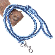 The Hobby Horse LarDen Knitted Lead Rope Double Blue—a soft paracord lead rope with a quality carabiner—is wrapped around a piece of wood.