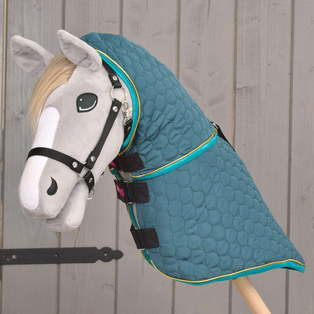 Quilted green Hobby Horse blanket with removable neck cover worn on a grey Hobby Horse