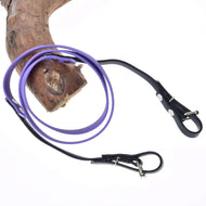 The Hobby Horse LarDen Reins Rubberized Light Purple is coiled on a tree branch against a white background, evoking the quality of bitless bridle reins.