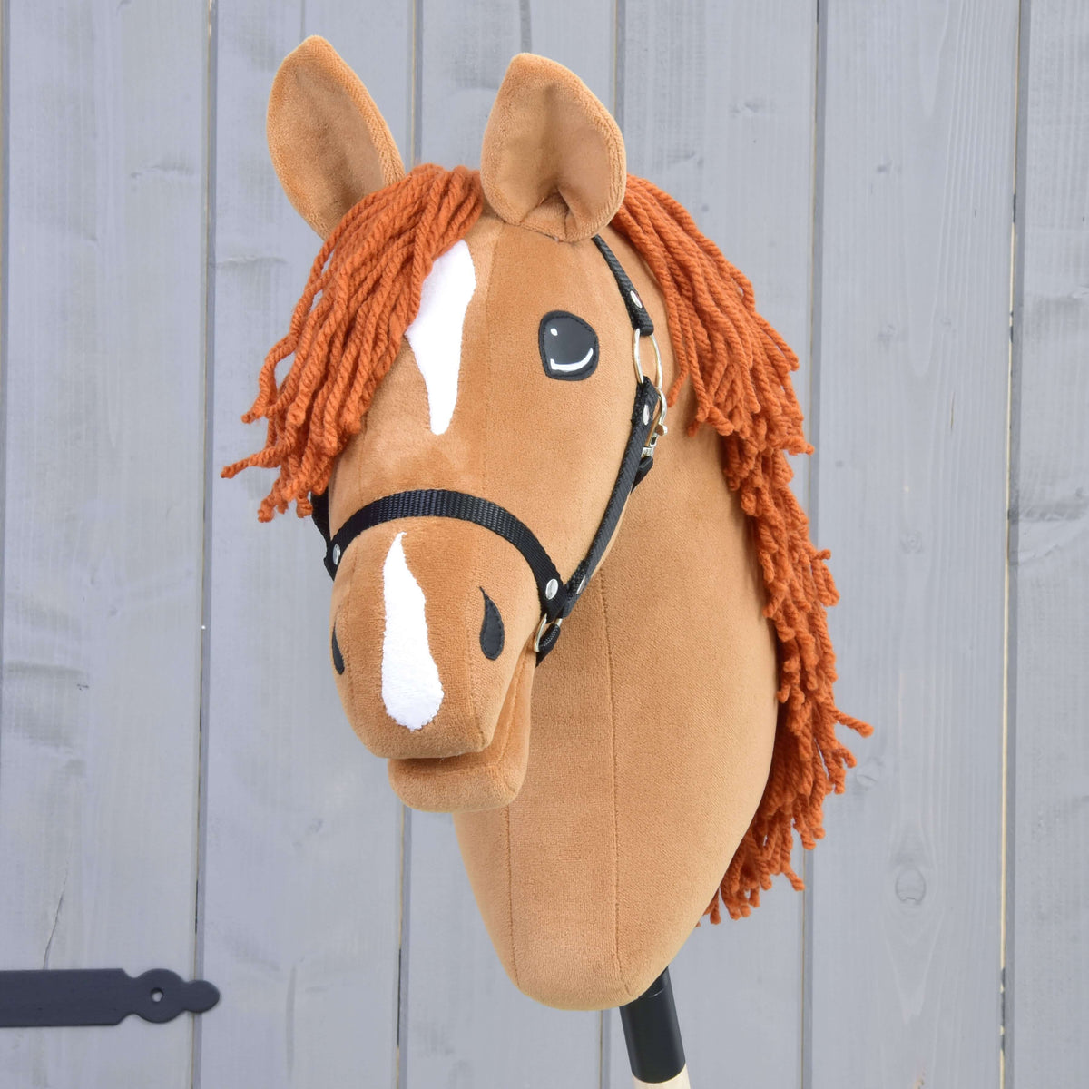 The Hobby Horse LarDen Little Angel with Black Halter features a chestnut Czech Warmblood look, white blaze and nose markings, orange yarn mane, and sits against a light gray wooden background.