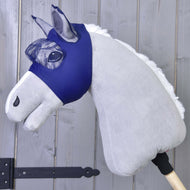 The Fly Mask LarDen by Hobby Horse LarDen features a plush hobby horse with a light gray body, white mane, and washable fly mask on a wooden stick, shown against a wooden panel background.