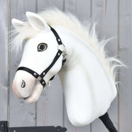 The Hobby Horse Nexus with Black Halter by Hobby Horse LarDen features a white plush Akhal-Teke-inspired head with button eye and fluffy mane, displayed against a wood wall—perfect for any Hobby Horse Nexus enthusiast.