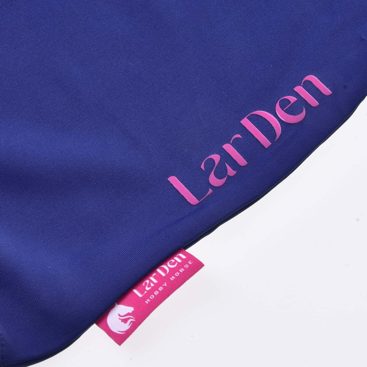 Detail of the Hobby Horse protective suit on white: pink LarDen print on navy lycra above the pink woven label