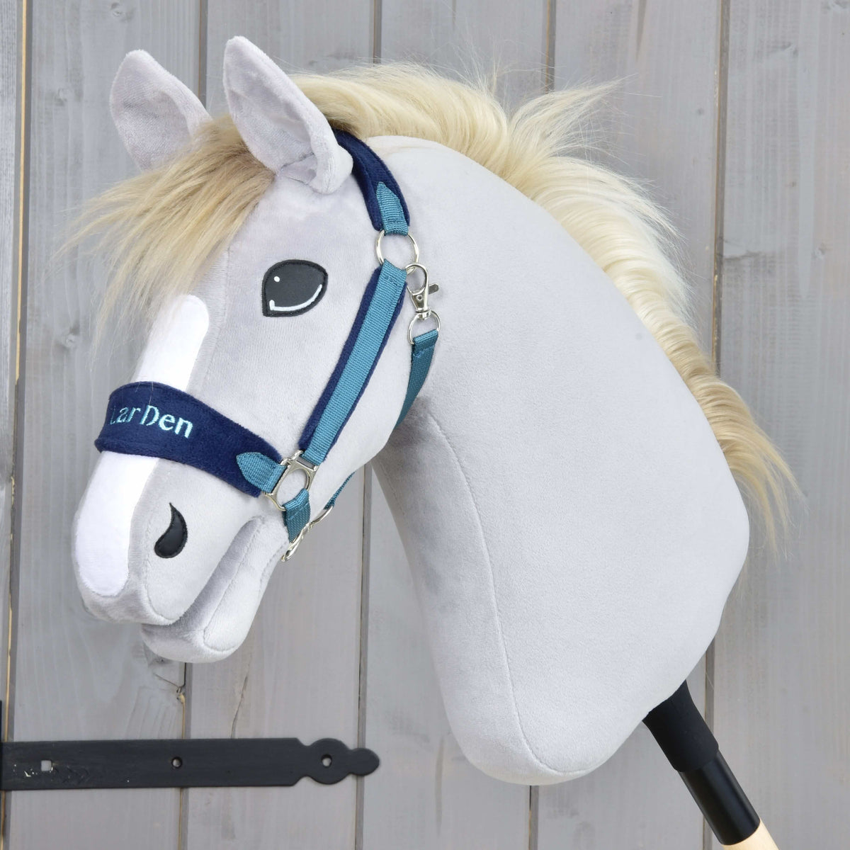 Grey plush Hobby Horse with a cream mane wearing the blue fur halter, LarDen embroidered on the navy noseband