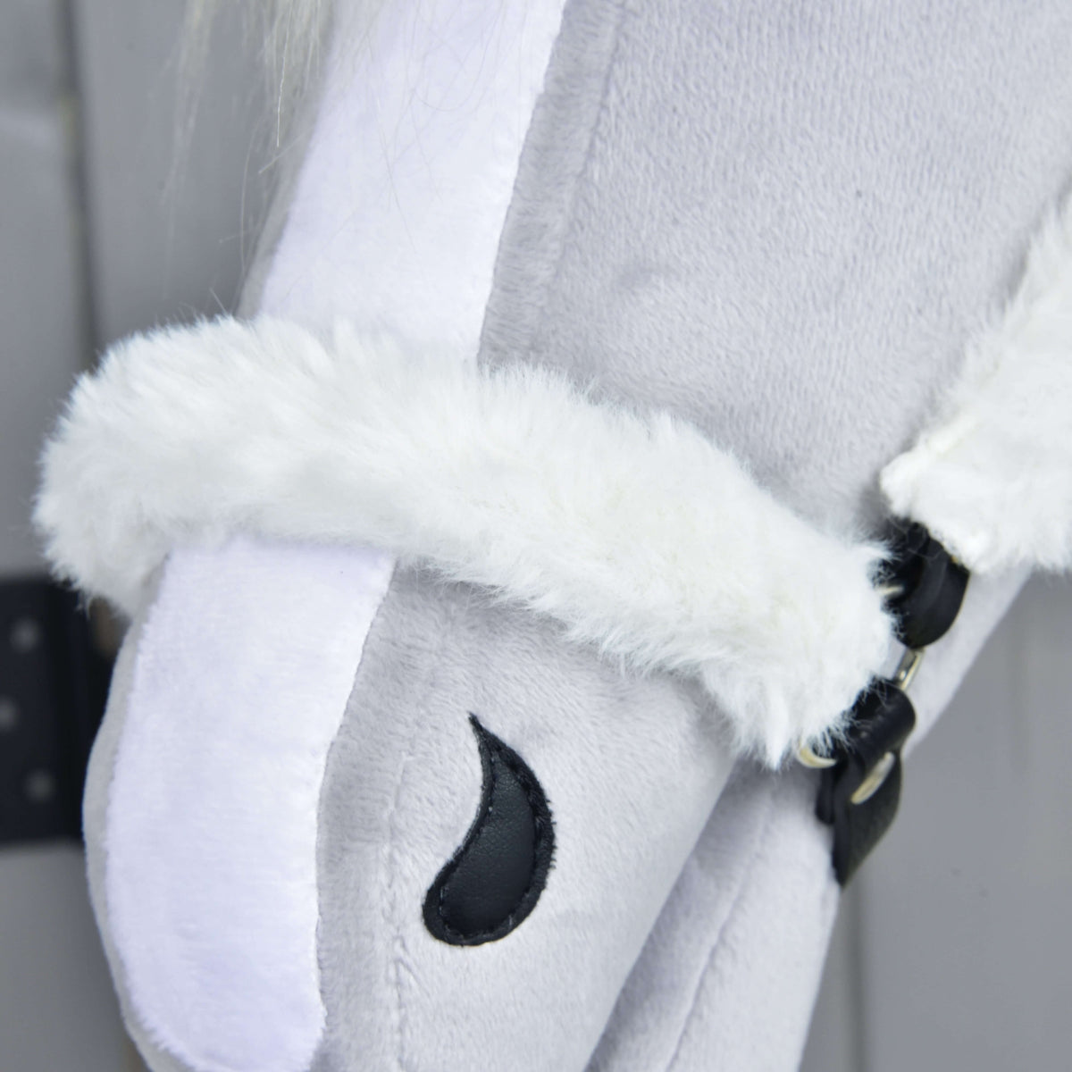 Close-up of the Hobby Horse LarDen Fur Halter Teddy Classic, a light gray plush hobby horse with a white fleece halter and black stitched eye detail, set against a gray background.