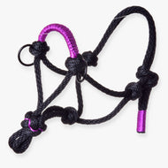 The Rope Halter Violette by Hobby Horse LarDen is a black halter with purple accents, featuring multiple knots and rings—a versatile accessory for handling, training, or hobby horse use.