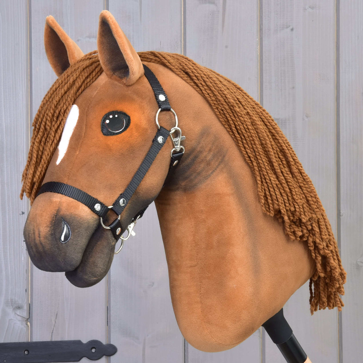 Hobby Horse Pippa with Black Halter by LarDen, a chestnut plush head with a small white stripe and a brown yarn mane